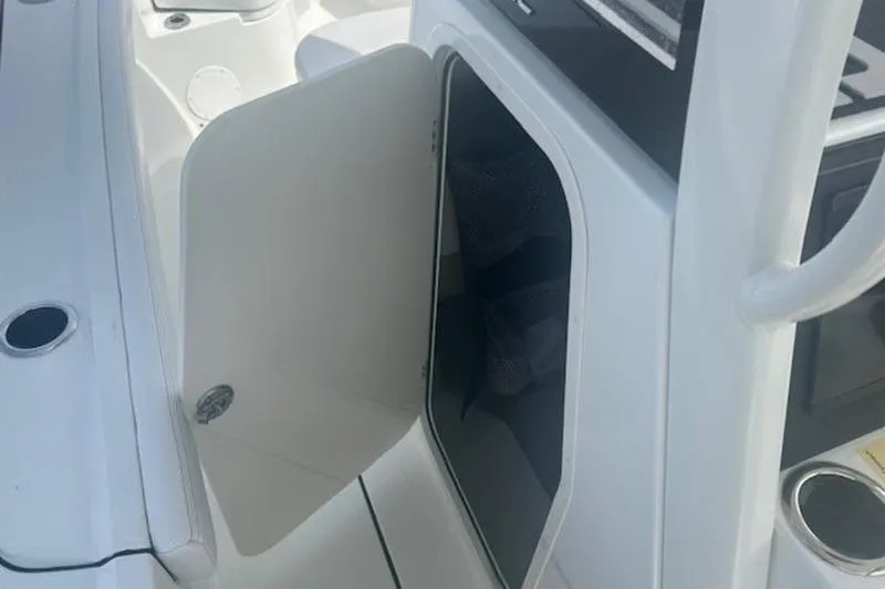Slide: The Image of Open storage compartment on 2025 Parker 2400 Center Console boat. - 15