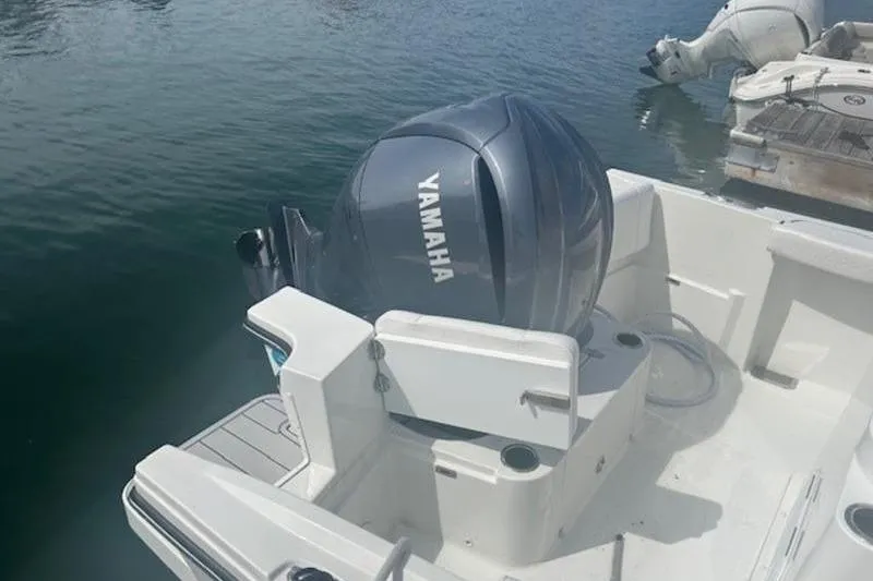 Slide: The Image of 2025 Parker 2400 Center Console boat with Yamaha outboard motor on calm water. - 16