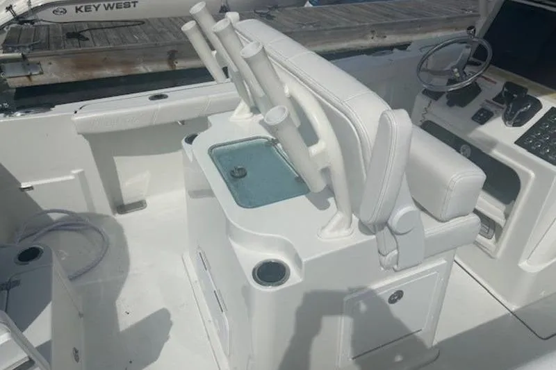 Slide: The Image of 2025 Parker 2400 Center Console boat interior with steering wheel and rod holders. - 17