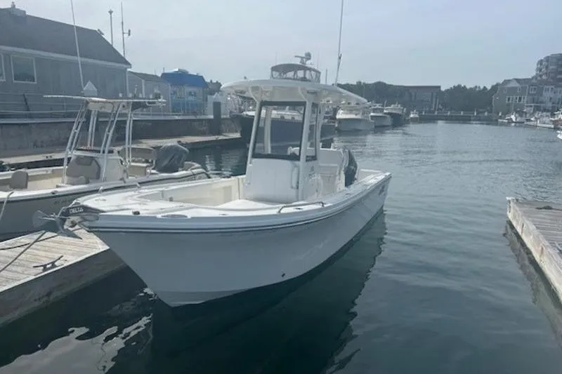 Slide: The Image of 2025 Parker 2400 Center Console boat docked in a marina, calm water, clear sky. - 2