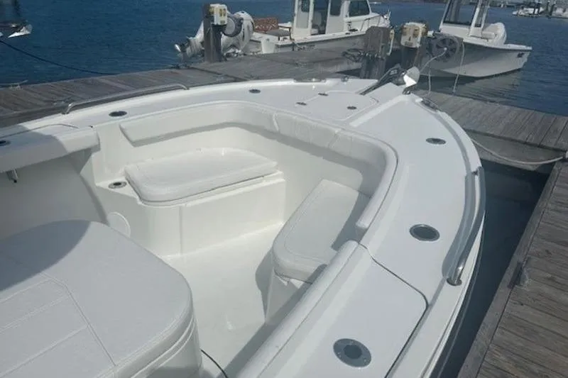 Slide: The Image of 2025 Parker 2400 Center Console boat docked, featuring spacious seating and sleek design. - 20