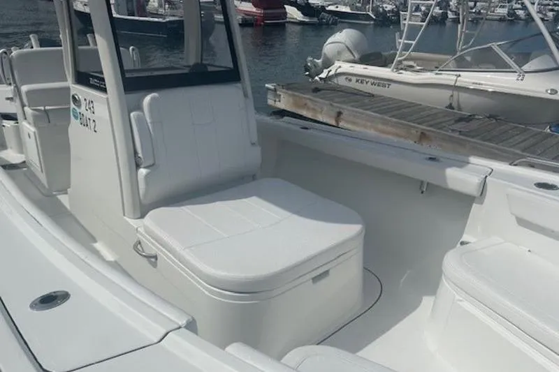 Slide: The Image of 2025 Parker 2400 Center Console boat docked at marina, featuring spacious seating. - 3