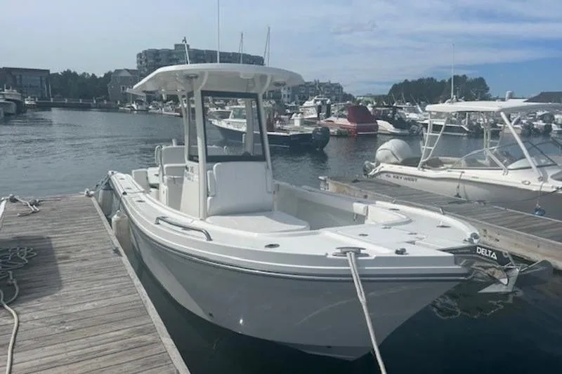Slide: The Image of 2025 Parker 2400 Center Console boat docked in a marina, surrounded by other vessels. - 5