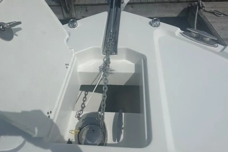 Slide: The Image of 2025 Parker 2400 Center Console boat anchor compartment with chain and winch. - 7