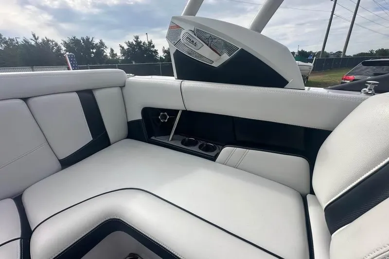 Slide: The Image of Interior of 2015 Nautique Super Air Nautique 210 boat with white and black seating. - 11