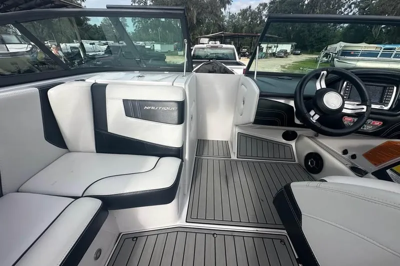 Slide: The Image of 2015 Nautique Super Air Nautique 210 interior with sleek seating and modern dashboard. - 13