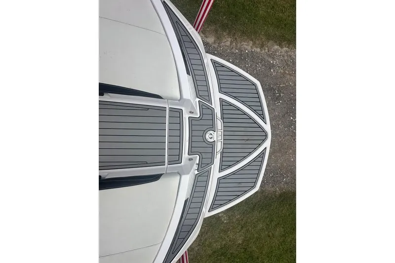 Slide: The Image of 2015 Nautique Super Air Nautique 210 boat deck, featuring sleek gray and white design. - 6