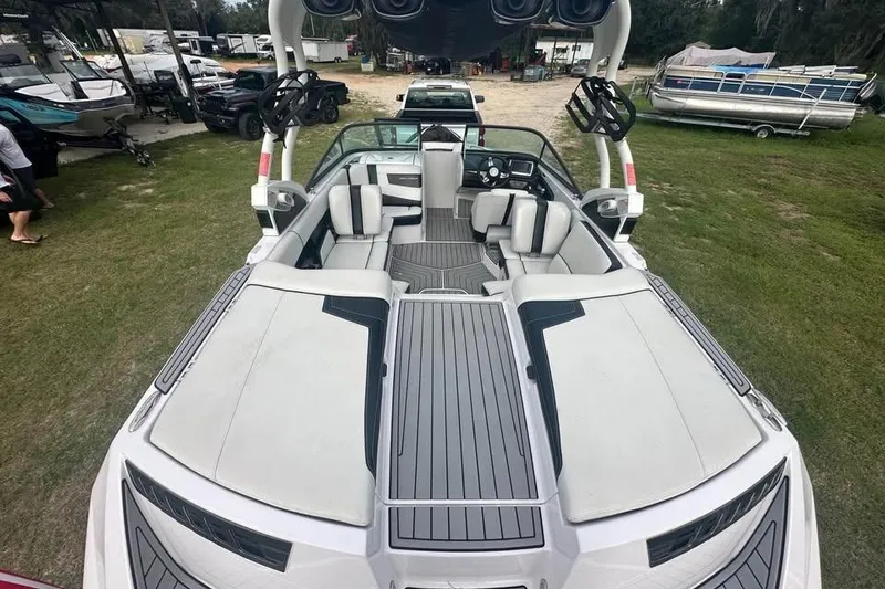 Slide: The Image of 2015 Nautique Super Air Nautique 210 boat interior with seating and speakers. - 7