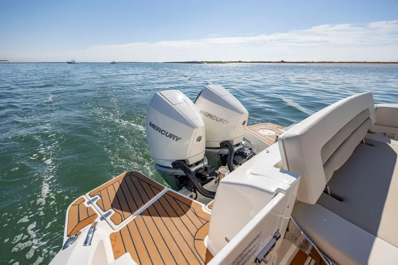 Slide: The Image of 2023 Boston Whaler 320 Vantage with dual Mercury engines on open water. - 16