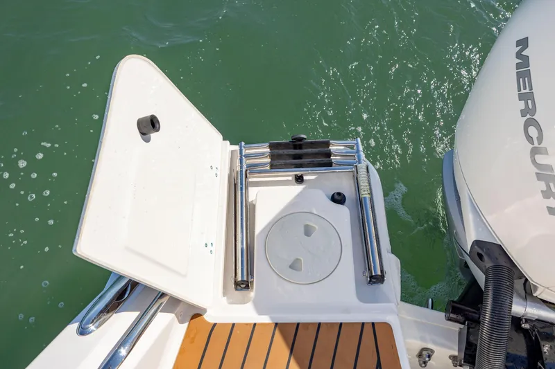 Slide: The Image of 2023 Boston Whaler 320 Vantage swim platform with ladder and Mercury engine. - 17
