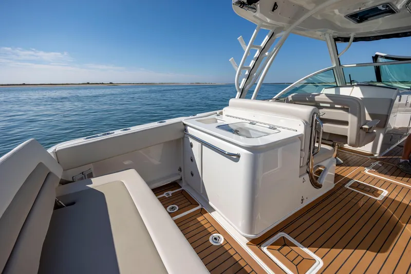 Slide: The Image of 2023 Boston Whaler 320 Vantage boat interior with sleek seating and ocean view. - 22