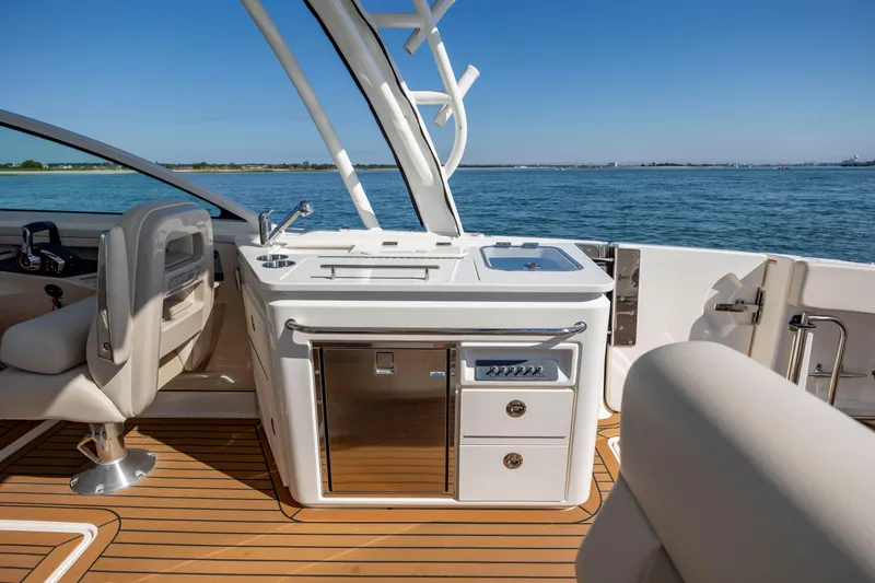 Slide: The Image of 2023 Boston Whaler 320 Vantage boat interior with sleek kitchen and ocean view. - 24
