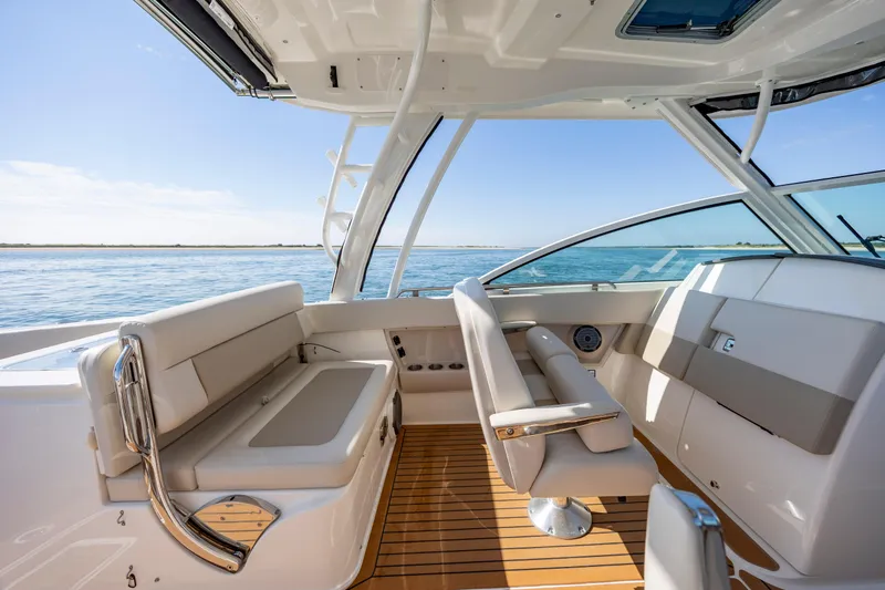Slide: The Image of 2023 Boston Whaler 320 Vantage interior with luxurious seating and ocean view. - 27