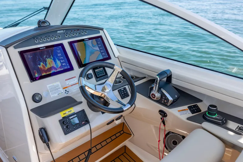 Slide: The Image of 2023 Boston Whaler 320 Vantage helm with advanced navigation displays and controls. - 30