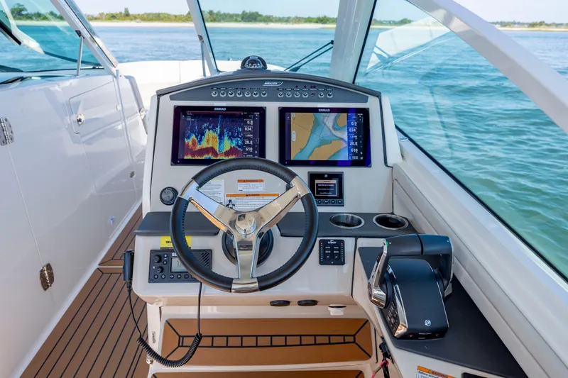 Slide: The Image of 2023 Boston Whaler 320 Vantage helm with advanced navigation displays and controls. - 31