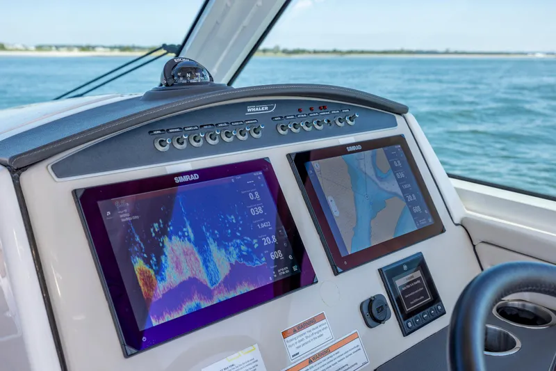 Slide: The Image of 2023 Boston Whaler 320 Vantage dashboard with navigation screens and controls. - 32