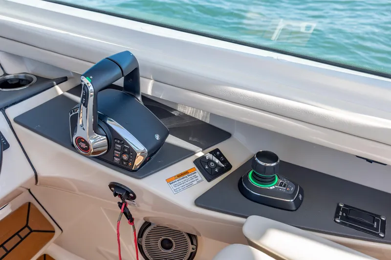 Slide: The Image of Control panel of 2023 Boston Whaler 320 Vantage boat, featuring modern throttle and joystick. - 33