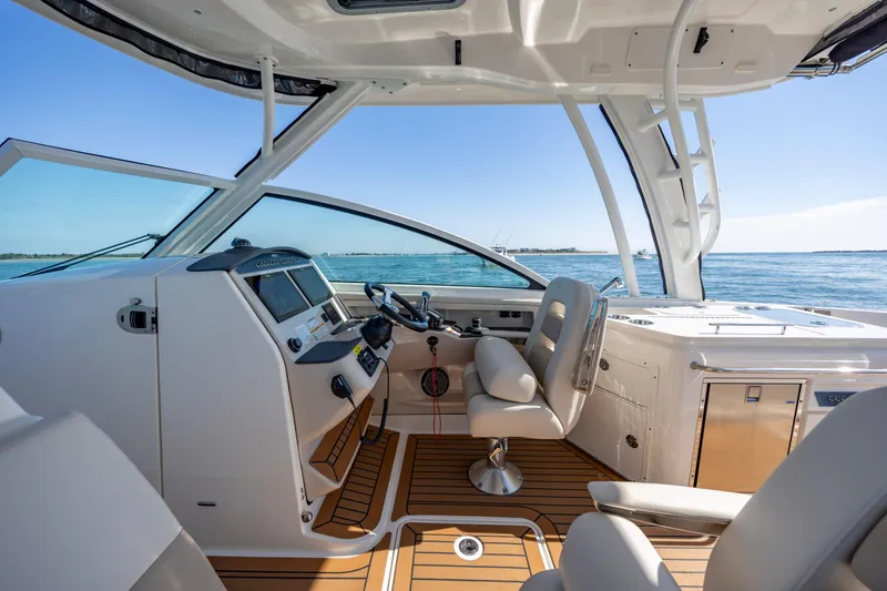 Slide: The Image of 2023 Boston Whaler 320 Vantage helm with luxurious seating and ocean view. - 34