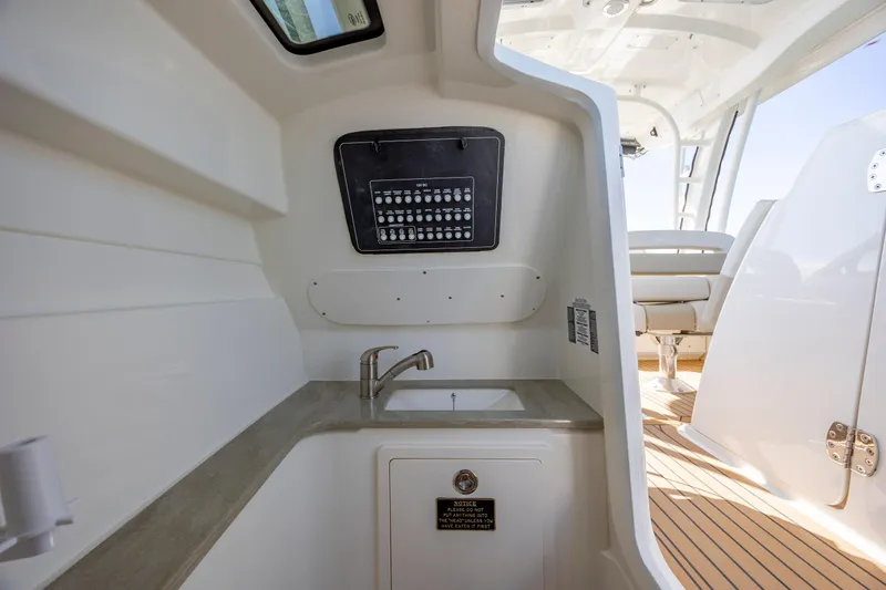 Slide: The Image of 2023 Boston Whaler 320 Vantage interior with sink and control panel. - 36
