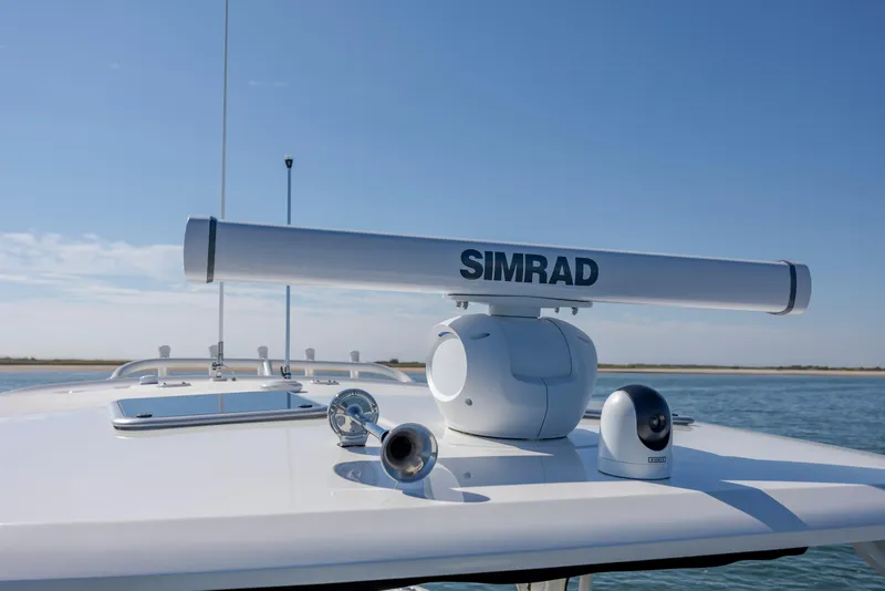 Slide: The Image of 2023 Boston Whaler 320 Vantage with Simrad radar on deck, ocean backdrop. - 40