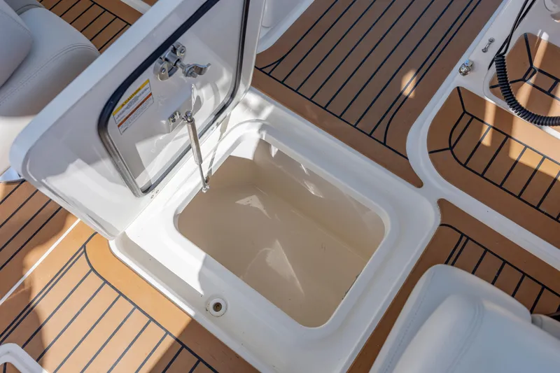 Slide: The Image of 2023 Boston Whaler 320 Vantage storage compartment with open hatch on deck. - 41