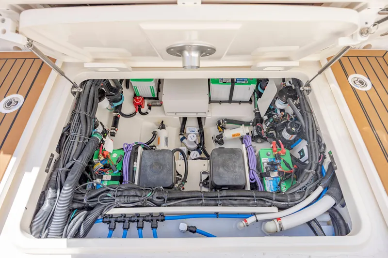 Slide: The Image of 2023 Boston Whaler 320 Vantage engine compartment with organized wiring and components. - 42