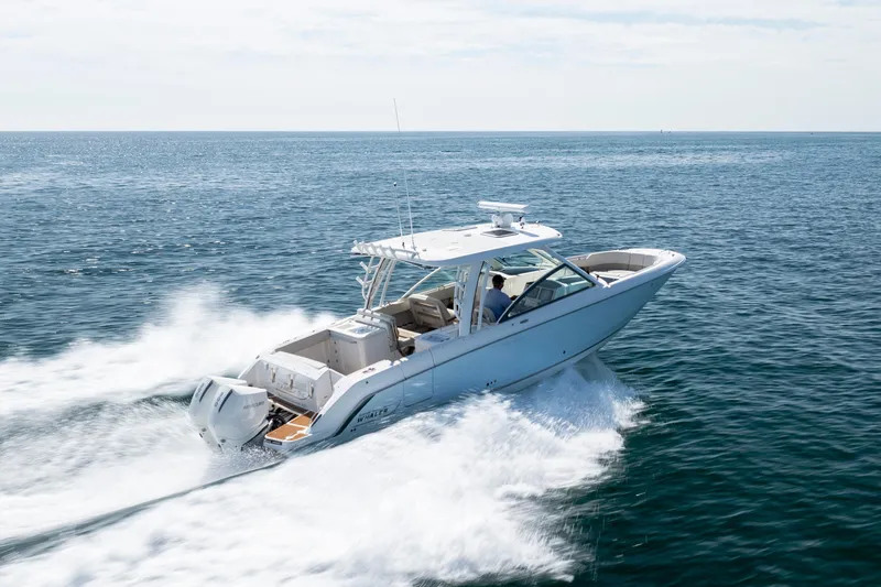 Slide: The Image of 2023 Boston Whaler 320 Vantage cruising on open water, showcasing sleek design and performance. - 44