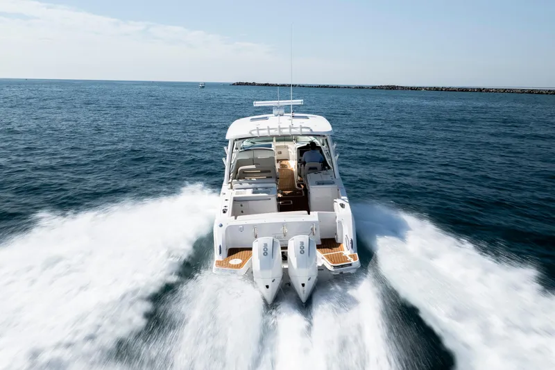 Slide: The Image of 2023 Boston Whaler 320 Vantage cruising on open water, showcasing powerful dual engines. - 45