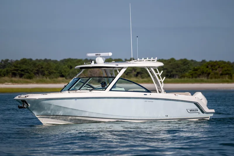 Slide: The Image of 2023 Boston Whaler 320 Vantage boat on calm water, side view. - 9