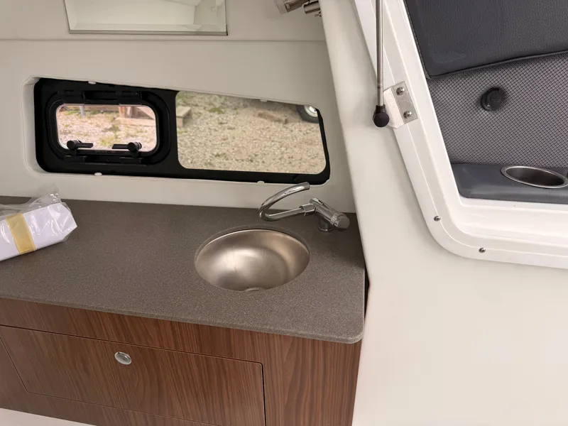Slide: The Image of Interior of 2024 Scarab 285 Wake ID with sink and window. - 23