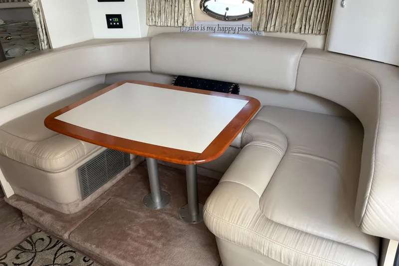 Slide: The Image of Interior of 2000 Formula 34 Performance Cruiser with beige leather seating and wooden table. - 10