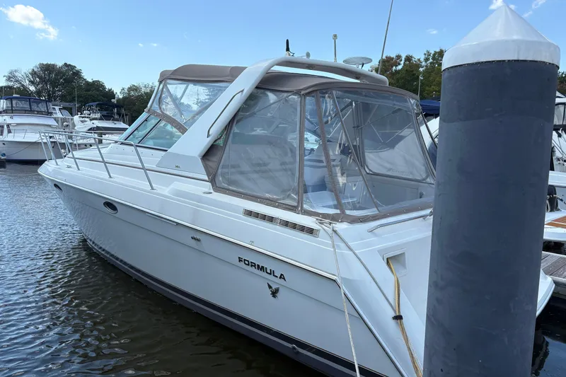 Slide: The Image of 2000 Formula 34 Performance Cruiser docked at marina, featuring sleek design and spacious cabin. - 3