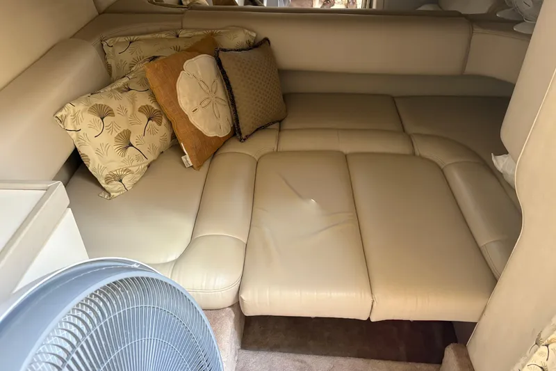 Slide: The Image of Cozy interior of 2000 Formula 34 Performance Cruiser with beige seating and decorative pillows. - 9