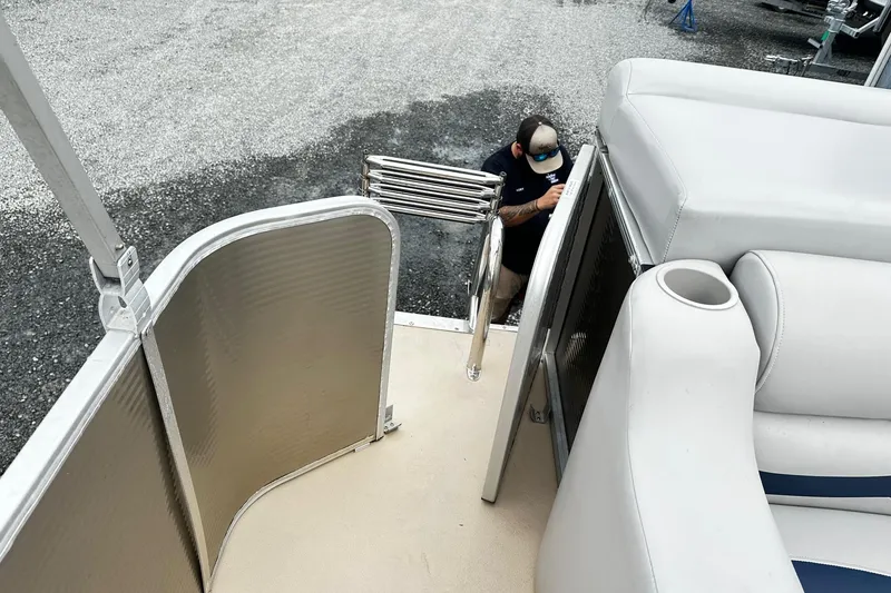 Slide: The Image of 2007 Godfrey Sweetwater Tuscany boat interior with seating and a person outside. - 10