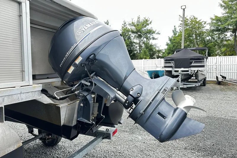 Slide: The Image of 2007 Godfrey Sweetwater Tuscany with Yamaha outboard motor in a boatyard. - 11