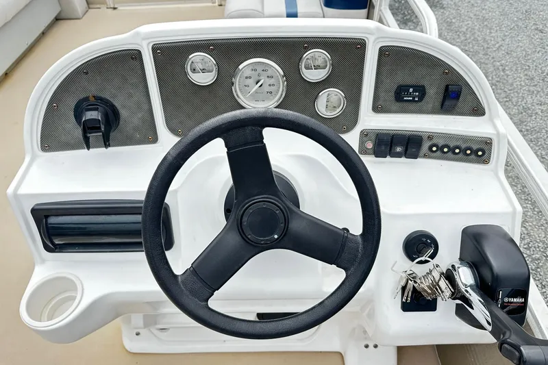 Slide: The Image of 2007 Godfrey Sweetwater Tuscany boat dashboard with steering wheel and Yamaha controls. - 3