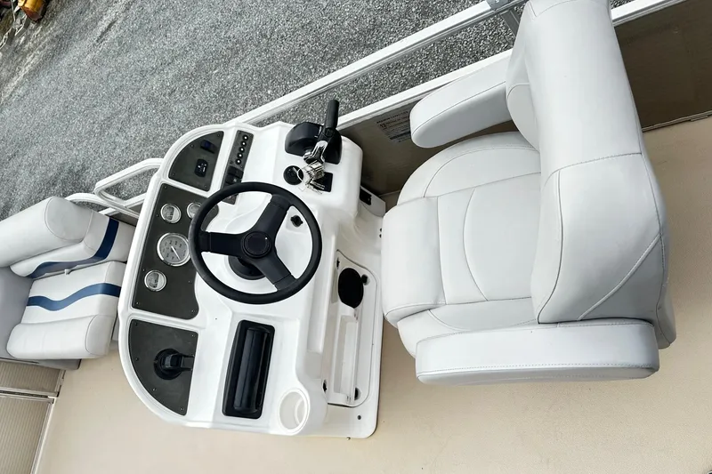 Slide: The Image of 2007 Godfrey Sweetwater Tuscany boat helm with white captain's chair and control panel. - 4