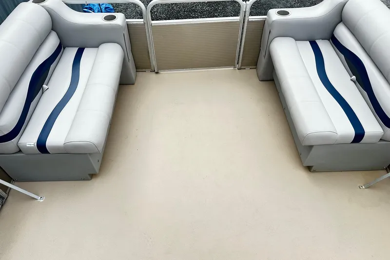 Slide: The Image of 2007 Godfrey Sweetwater Tuscany boat interior with white and blue cushioned seating. - 9