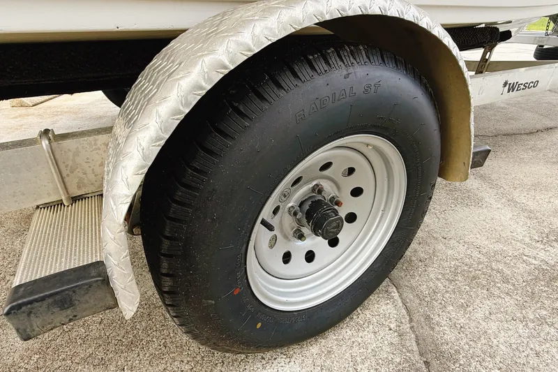 Slide: The Image of Trailer wheel of a 2005 Nitro Bay boat with radial tire and metal fender. - 15