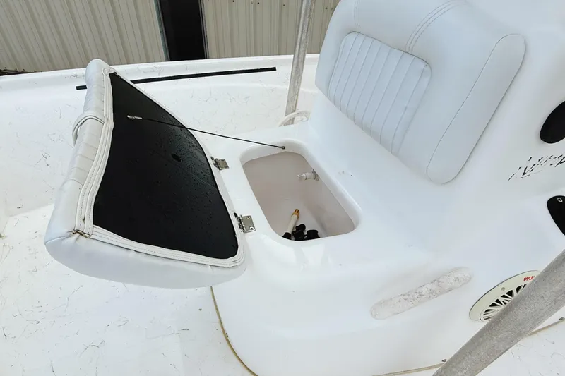 Slide: The Image of 2005 Nitro Bay boat seat with open storage compartment, white upholstery. - 7