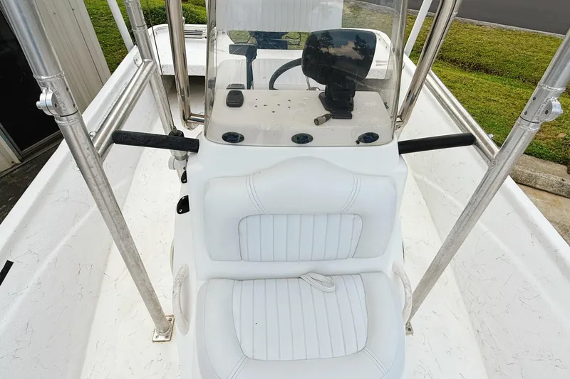 Slide: The Image of 2005 Nitro Bay boat interior with white seating and steering console. - 8