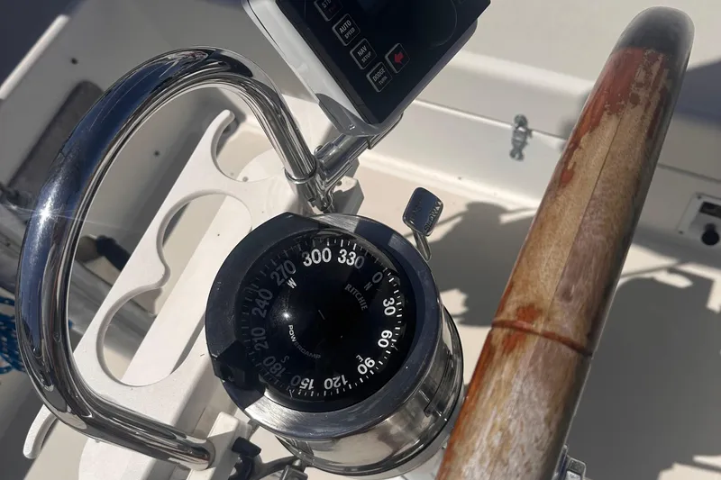 Slide: The Image of Steering wheel and compass on a 1978 Pearson 424 sailboat. - 15