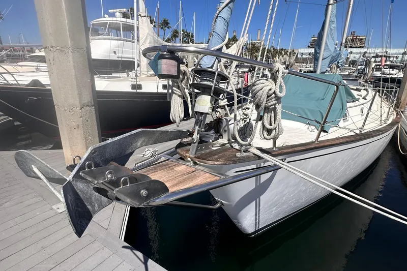 Slide: The Image of 1978 Pearson 424 sailboat docked, featuring anchor and ropes on deck. - 2