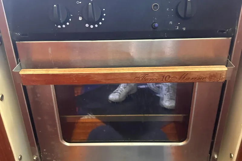 Slide: The Image of Force 10 Marine oven on 1978 Pearson 424 sailboat, featuring wooden handle and control knobs. - 22