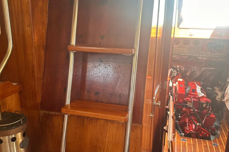 Slide: The Image of Interior of 1978 Pearson 424 sailboat showing wooden ladder and engine compartment. - 26