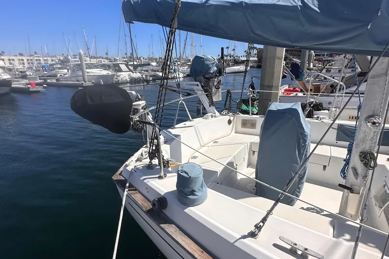 Slide: The Image of 1978 Pearson 424 sailboat docked in marina, featuring covered cockpit and clear blue sky. - 3