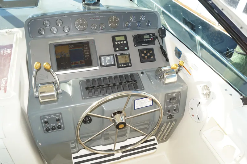 Slide: The Image of Helm of 1995 Tiara Yachts 4000 Express with navigation instruments and steering wheel. - 23