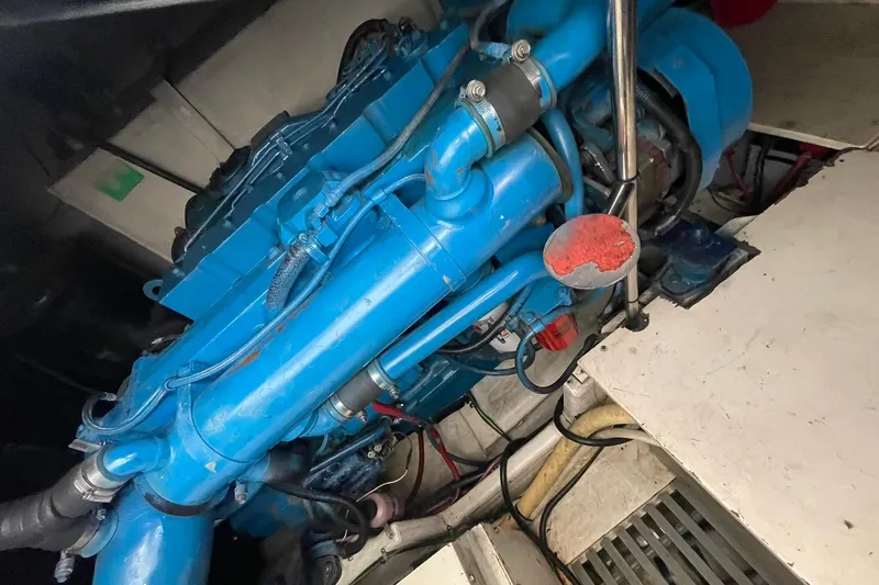 Slide: The Image of Engine compartment of a 1995 Tiara Yachts 4000 Express, featuring a blue marine engine. - 35
