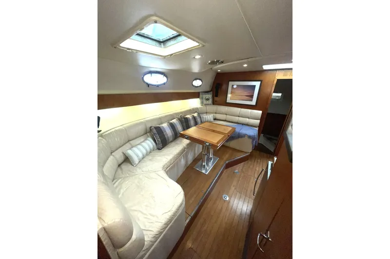 Slide: The Image of Luxurious interior of 1995 Tiara Yachts 4000 Express with plush seating and wooden table. - 5