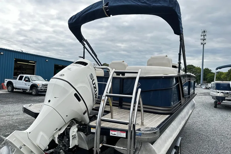 Slide: The Image of 2018 Godfrey San Pan Tri Toon pontoon boat with Suzuki outboard motor. - 2